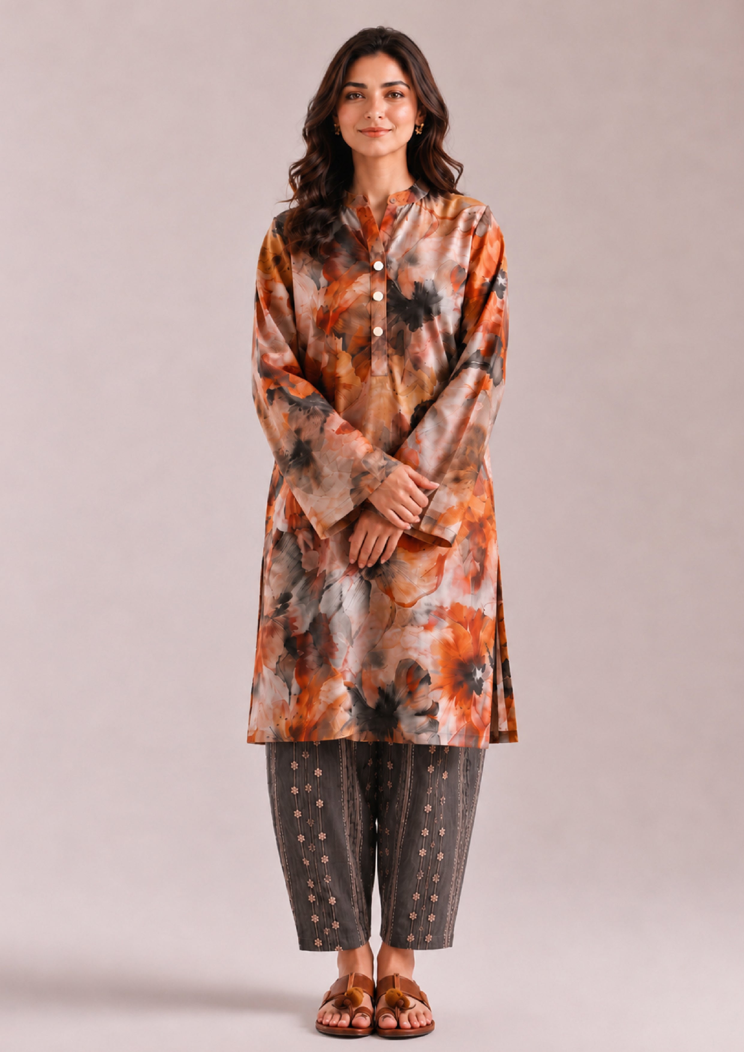 Front view of a women's Printed Lawn Suit in orange, beige and charcoal grey floral print with matching striped trousers from the Fasl-e-Rang collection by Mirasl.