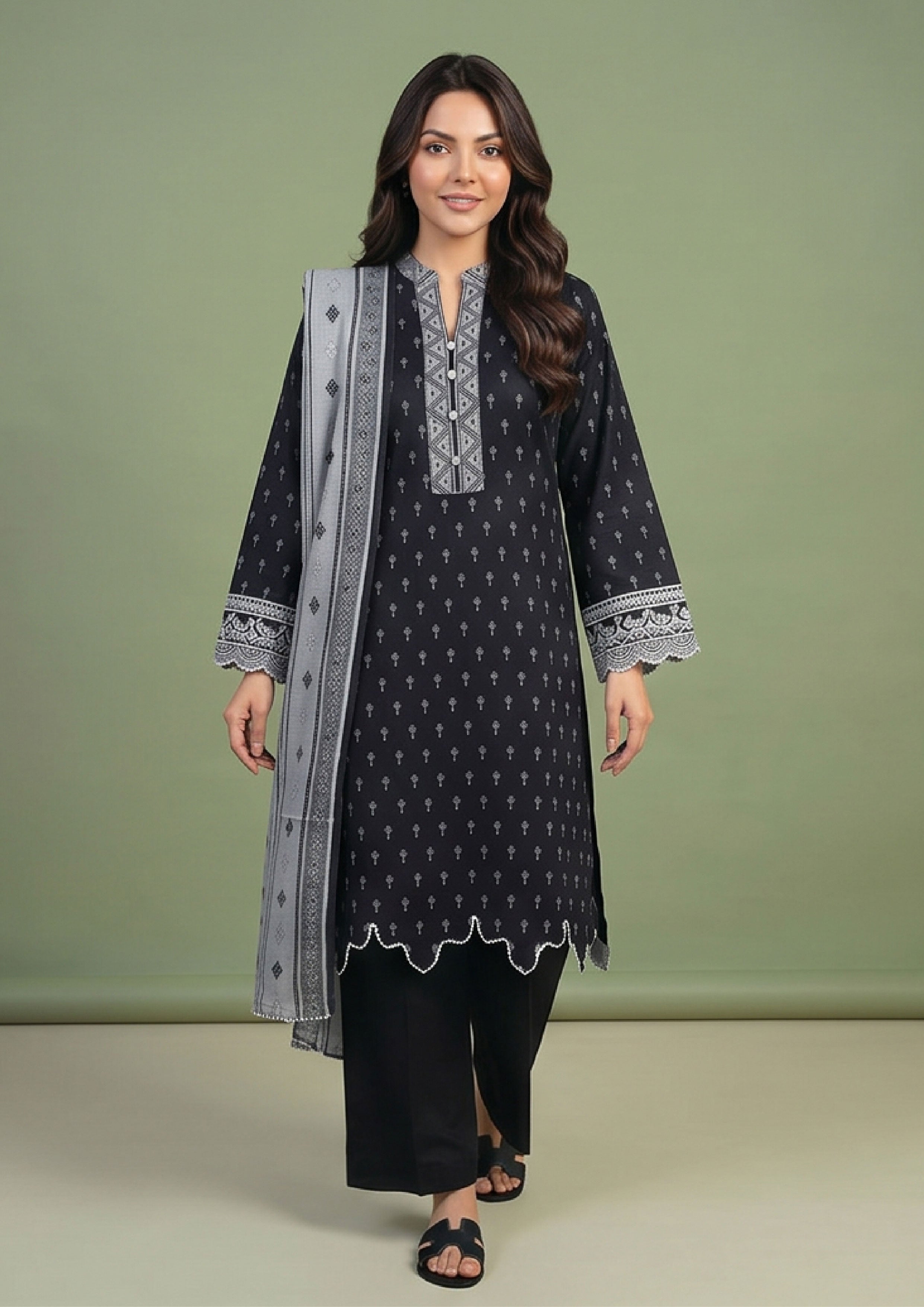 Pakistani black lawn suit by Mirasl with embroidered style neckline, scalloped hem detail and straight trouser