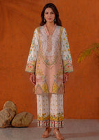 Model wearing Mirasl Peach Blossom, a 2 piece printed lawn co-ord set in soft peach, ivory, yellow and green floral print with printed straight trouser.