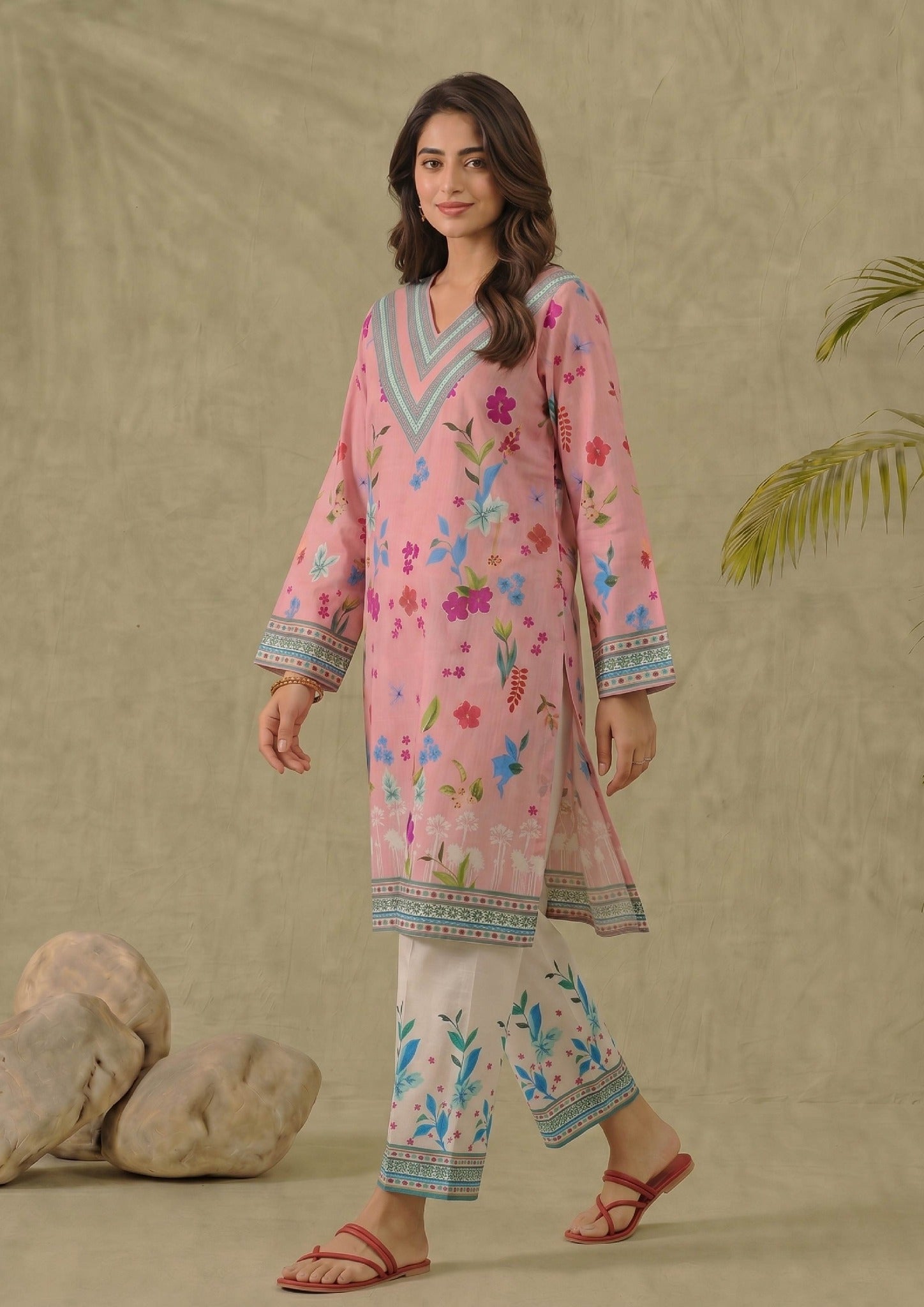 Seated view of Mirasl Petal Pink 2 piece printed lawn co-ord set with floral pink shirt and white printed trouser.