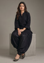 Detailed look of Pleated Afghani Noir 2 piece ready to wear suit with tonal pleated hem, sleeve texture and black Afghani shalwar
