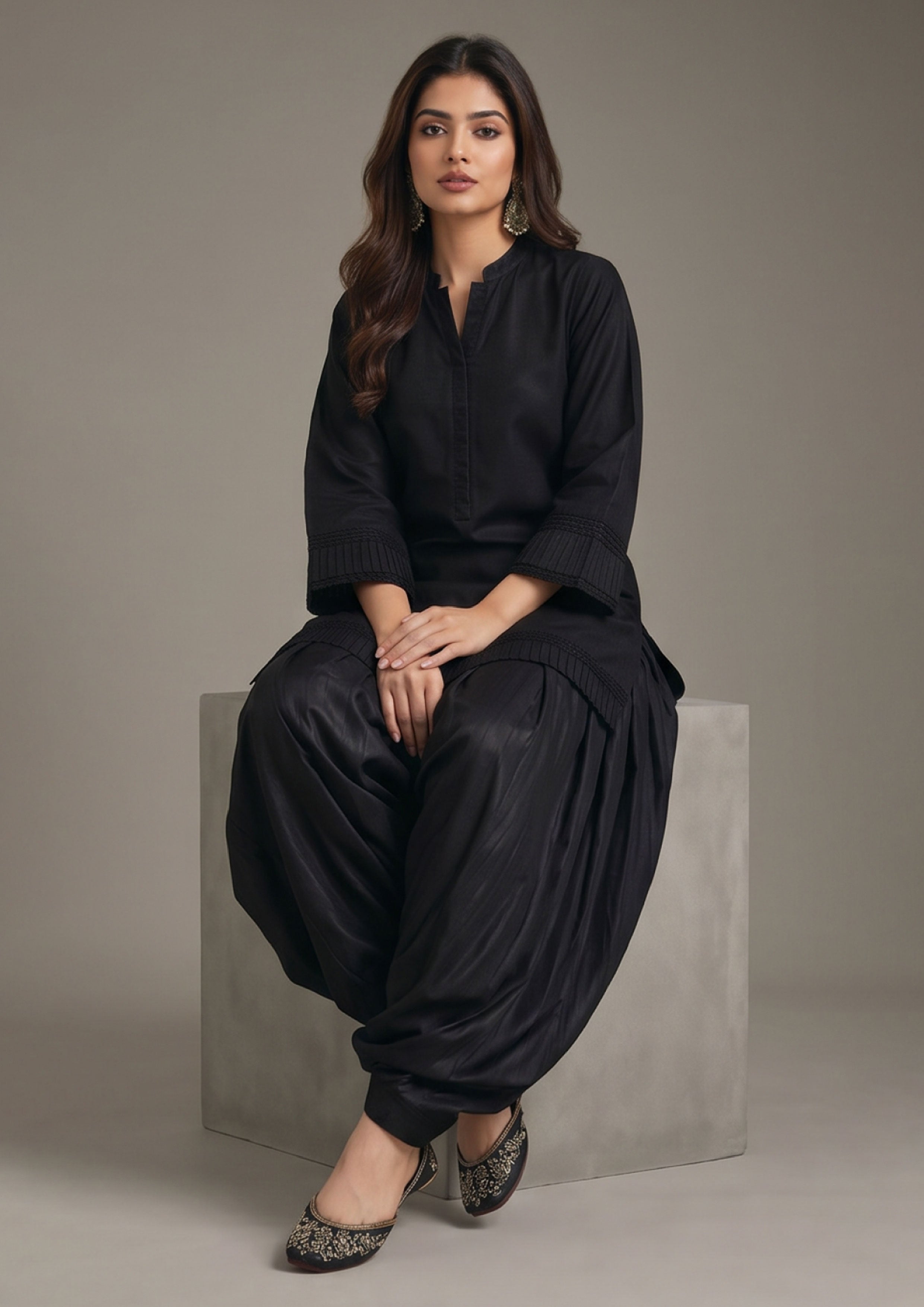 Detailed look of Pleated Afghani Noir 2 piece ready to wear suit with tonal pleated hem, sleeve texture and black Afghani shalwar