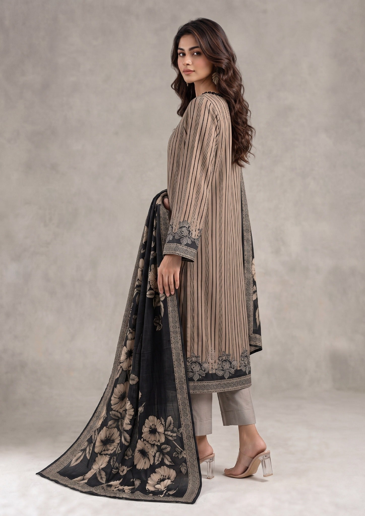 Seated view of Sepia Stripe 3 Piece Stitched Lawn Suit with beige striped shirt and black floral printed dupatta by Mirasl