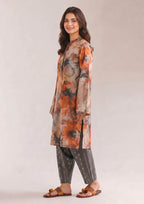 Side view of Mirasl Sienna Sunset printed lawn co-ord set with floral shirt and grey trouser.