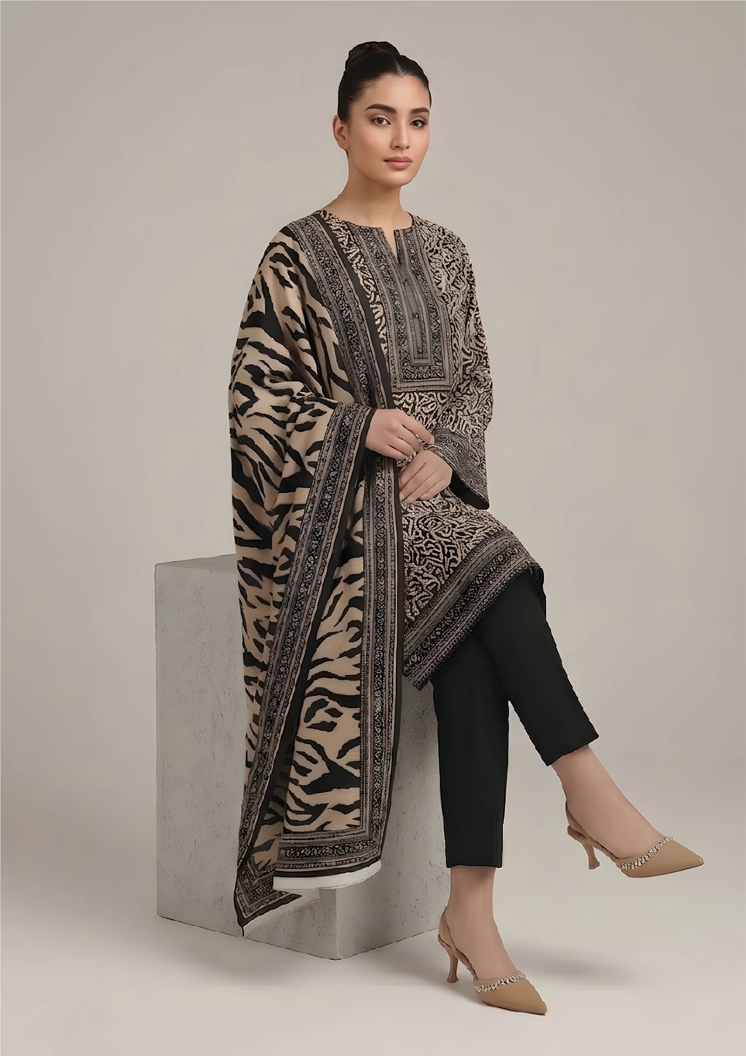 Side view of Urban Safari Noir black and sand lawn suit with flowing tiger stripe dupatta and tailored black trouser